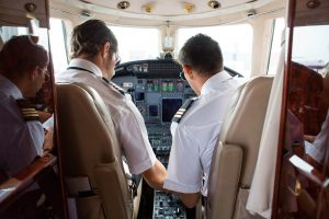 pilot-and-copilot-in-cockpit-of-corporate-jet-PUSAUJ5